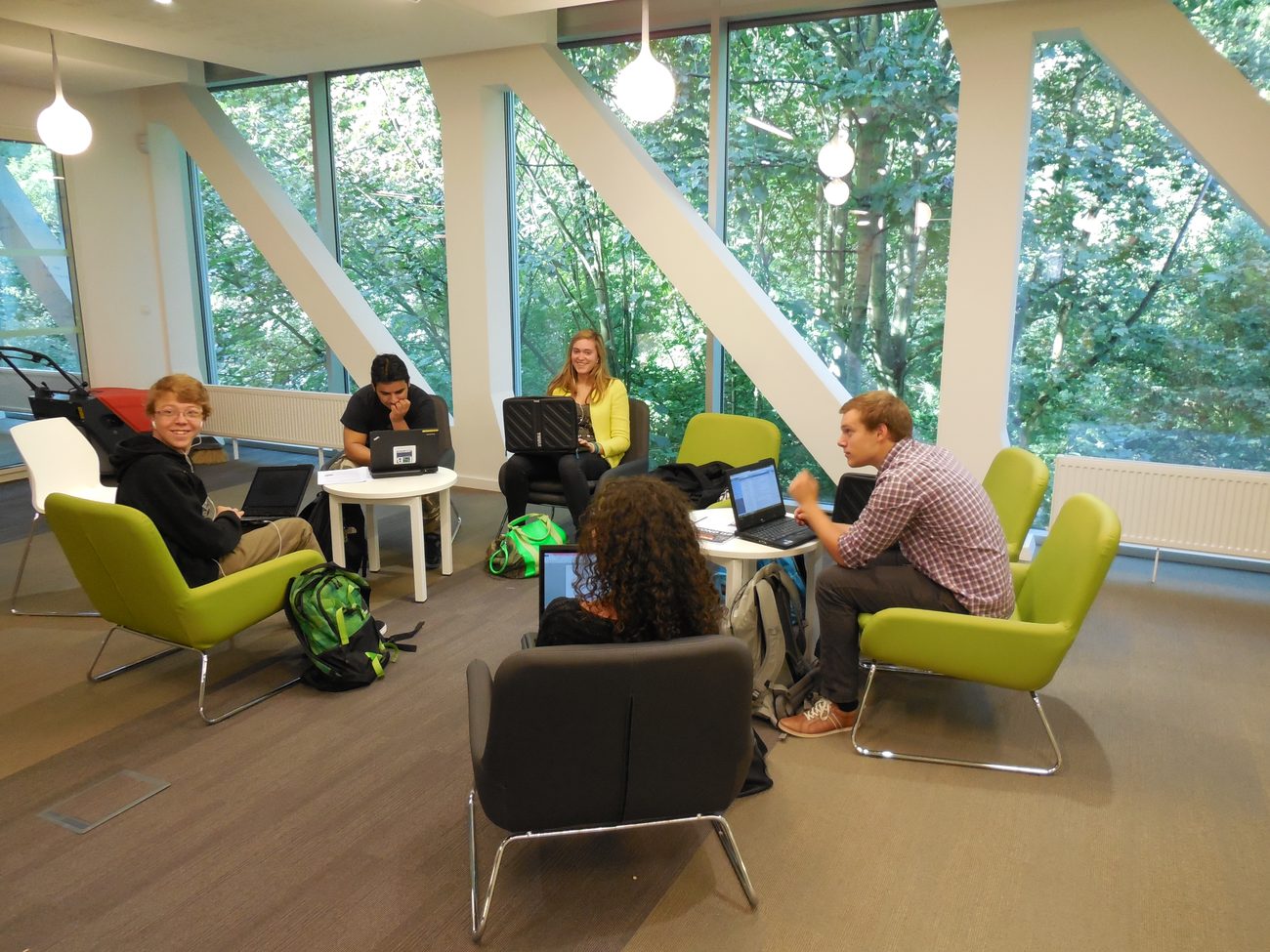 Students collaborating in a daylit, biophilic learning commons